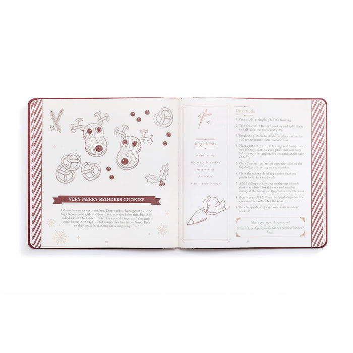 An open recipe book or cookbook showing illustrated pages about 'Very Merry Reindeer Cookies' with drawings of reindeer, cookies, and text instructions, photographed on a clean white background.