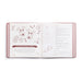 An open recipe book or cookbook showing illustrated pages about 'Very Merry Reindeer Cookies' with drawings of reindeer, cookies, and text instructions, photographed on a clean white background.