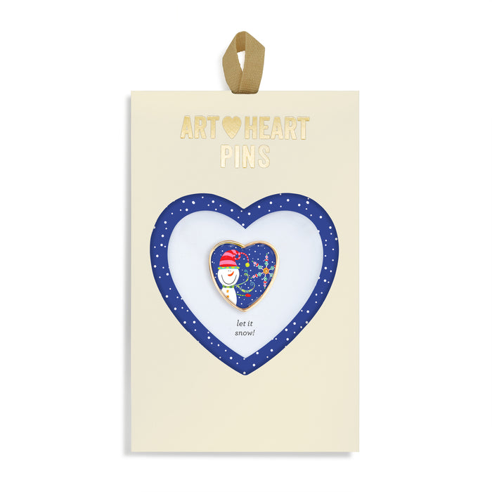 Heart-shaped pin with a snowman design on a branded card