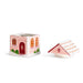 A gingerbread house shaped ceramic candle holder with its matching roof lid placed beside it on a clean white background.