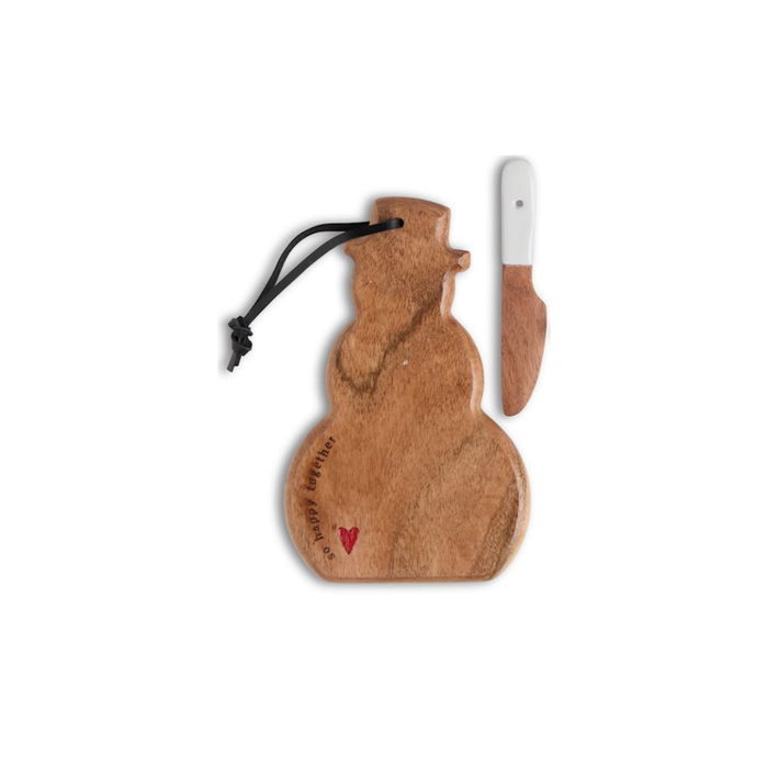 A wooden snowman-shaped serving board with a black hanging cord and a small red heart near the feet, shown next to a matching wooden knife with a white handle on a plain white background.