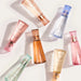 Collection of skincare bottles with different designs and colors on a light background