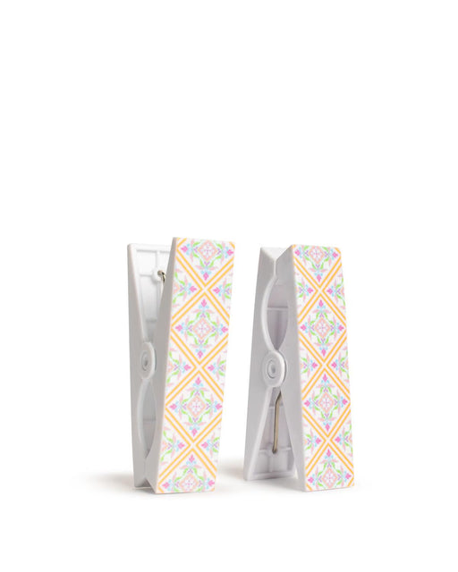 Two decorative clothespins with a colorful pattern on a white background