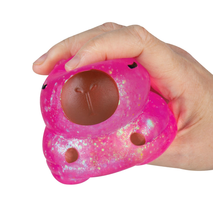Pink glittery stress ball with brown buttons held in a hand on a white background