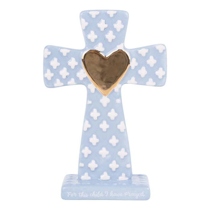 Decorative cross with a heart on a light blue background