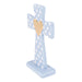 Decorative cross with a gold heart on a light blue stand against a white background