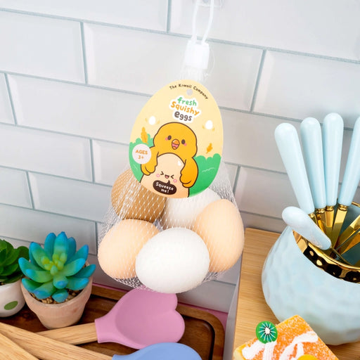Decorative set of squishy eggs with a chicken design on a kitchen counter.