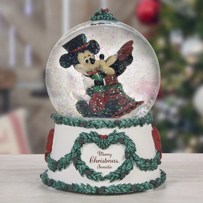 Christmas-themed snow globe with a character inside, decorated with festive elements.