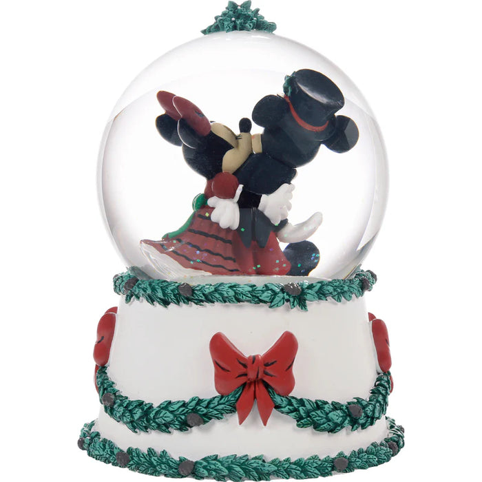 Christmas-themed snow globe with reindeer and decorative base on a white background