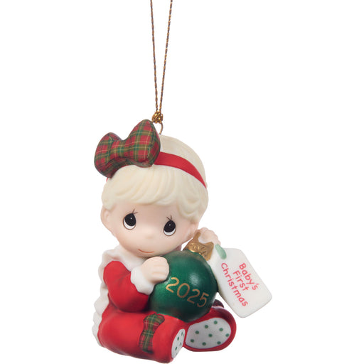 Christmas ornament of a girl with a green ball and '2025' on a white background