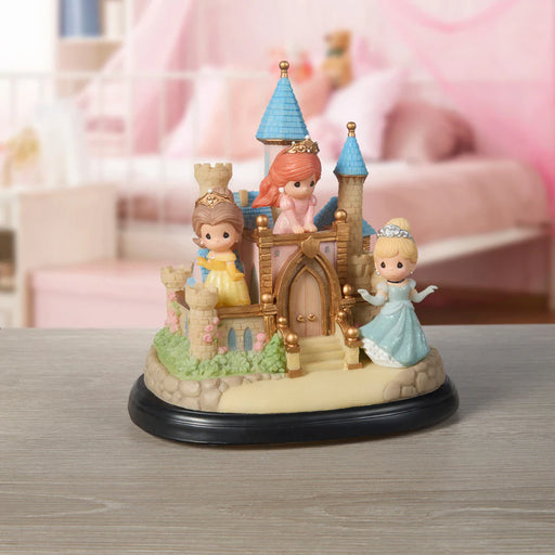 Toy castle with princess figures on a wooden surface