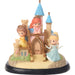 Toy castle with three princess figurines on a white background