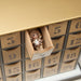 Advent calendar with numbered compartments and a small figurine inside one of the boxes.