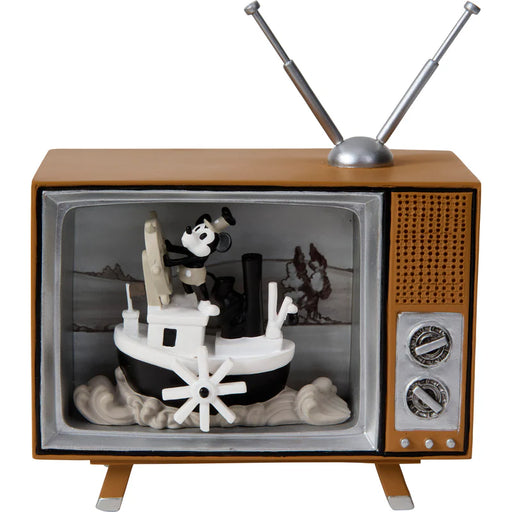 Vintage-style toy television with a small boat and figures inside on a white background