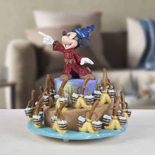 Decorative cake with a character figurine on top, surrounded by small bottles and decorative elements.