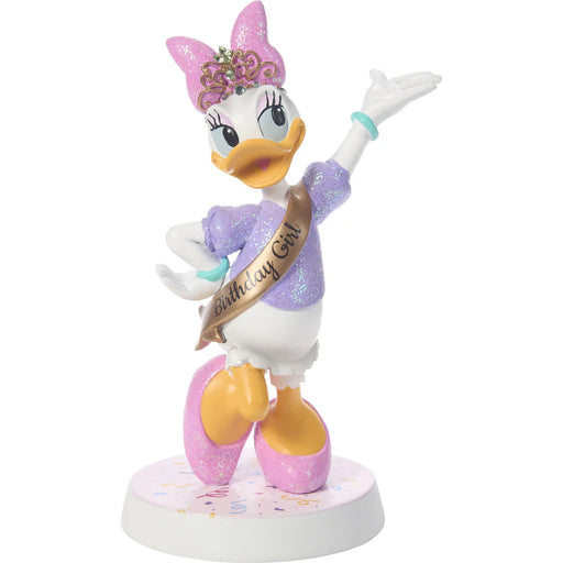 Animated character figurine with a birthday sash on a white background