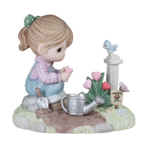 Figurine of a girl watering flowers with a birdhouse in the background