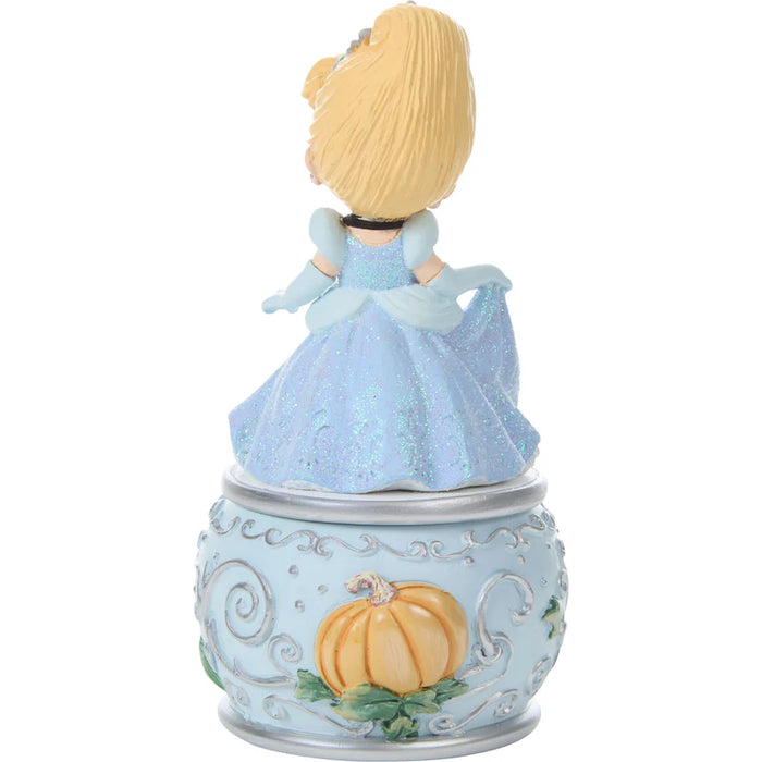 Figurine of a princess in a blue dress with a pumpkin on a white background