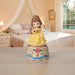 Princess figurine on a decorative base in a bedroom setting