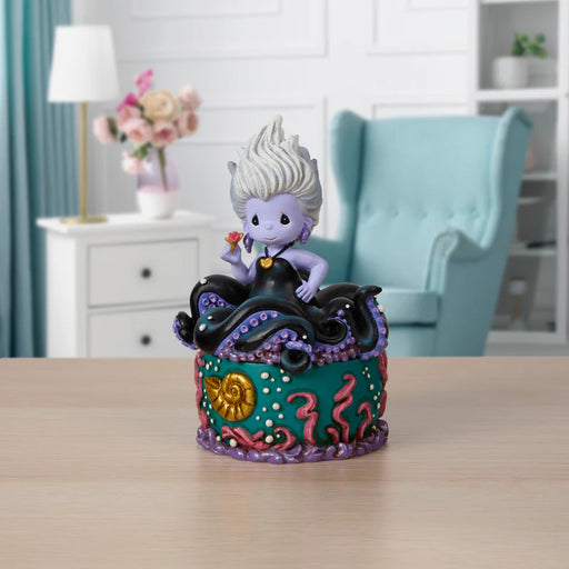 Colorful figurine on a decorative stand with a blurred indoor background