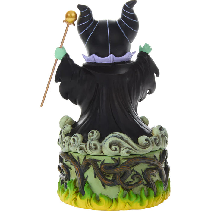 Statue of a witch with a staff on a white background
