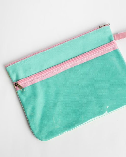 Turquoise pouch with pink zipper on a white background