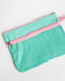 Turquoise pouch with pink zipper on a white background
