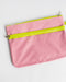 Pink pouch with a yellow zipper on a white background