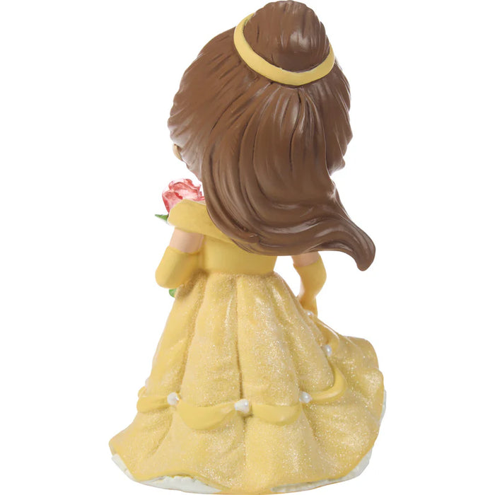 Figurine of a character in a yellow dress with a pink flower on a white background
