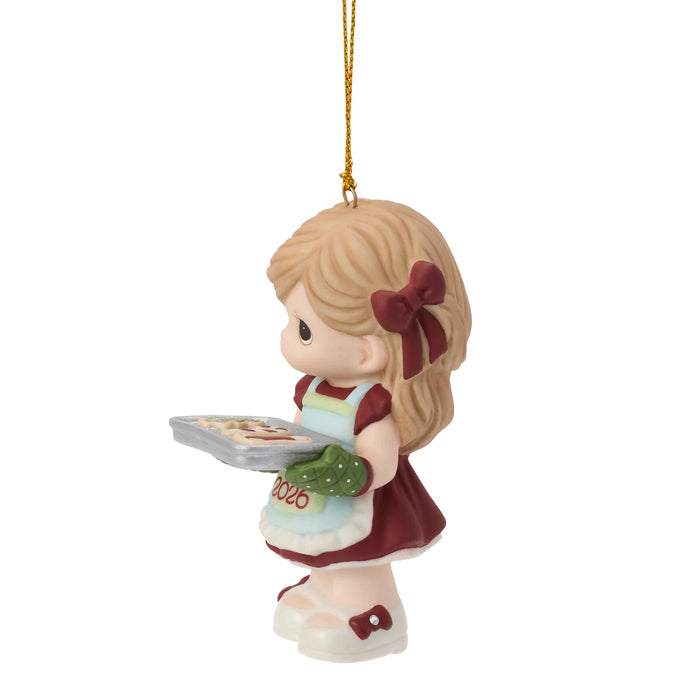 Ornament of a girl with a cookie tray on a white background