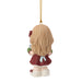 A small hanging ornament shaped like a child from the back, with long blonde hair, a burgundy dress, green sleeves, and white shoes, suspended by a gold string on a plain white background.