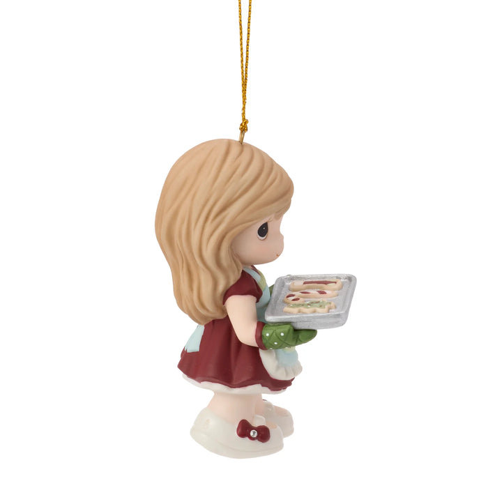 Ornament of a girl holding a tray with cookies on a white background