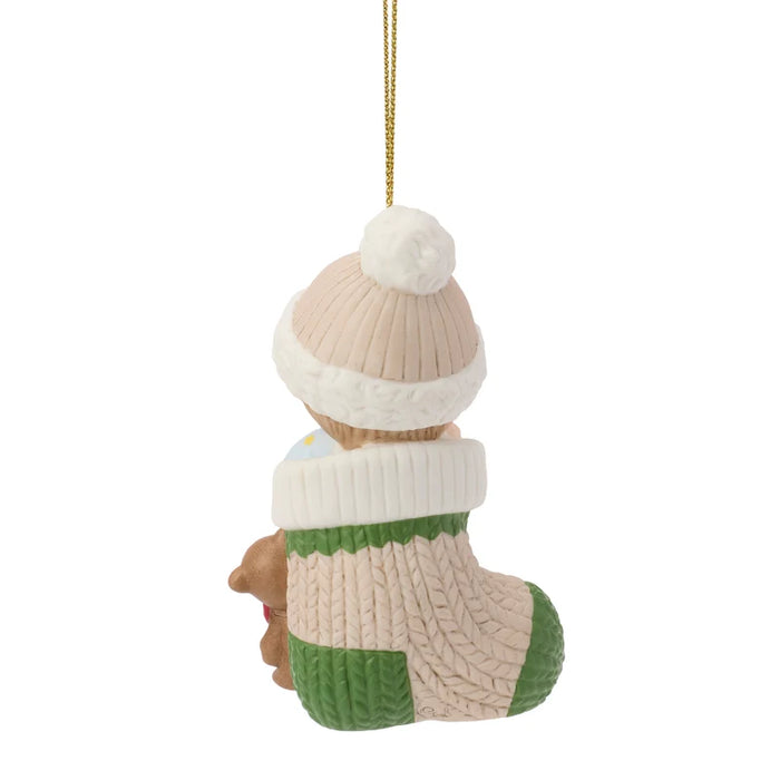Decorative ornament resembling a knitted boot with a white bobble hat on a white background