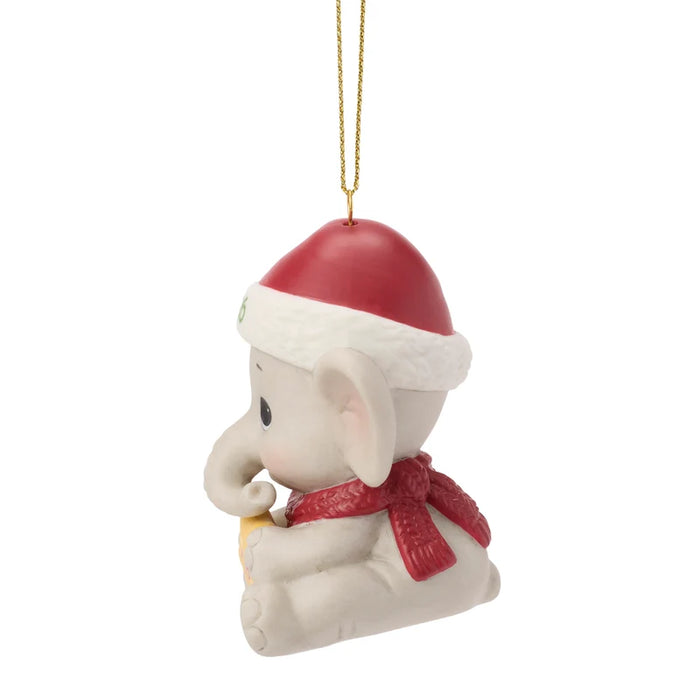 Christmas ornament of a baby elephant wearing a Santa hat and scarf on a white background