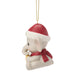 Christmas ornament of a baby elephant wearing a Santa hat and scarf on a white background