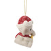 Christmas ornament of a elephant wearing a Santa hat and holding a present on a white background