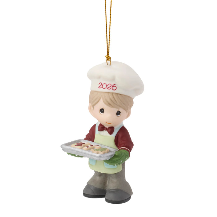 Decorative ornament of a chef holding a tray with '2026' on a white background