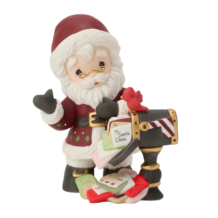 Santa Claus figurine with a mailbox and letters on a white background