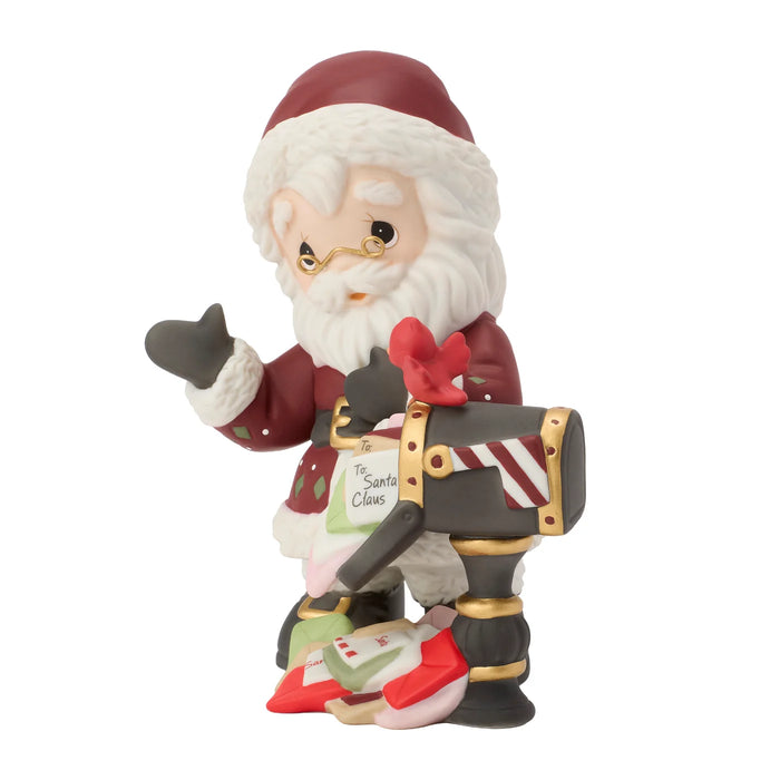 Decorative figurine of Santa Claus next to a mail box on a white background