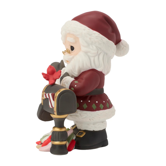 Santa Claus figurine next to a mailbox with a white background