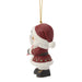 Christmas ornament of a small figure in a Santa hat and coat on a white background