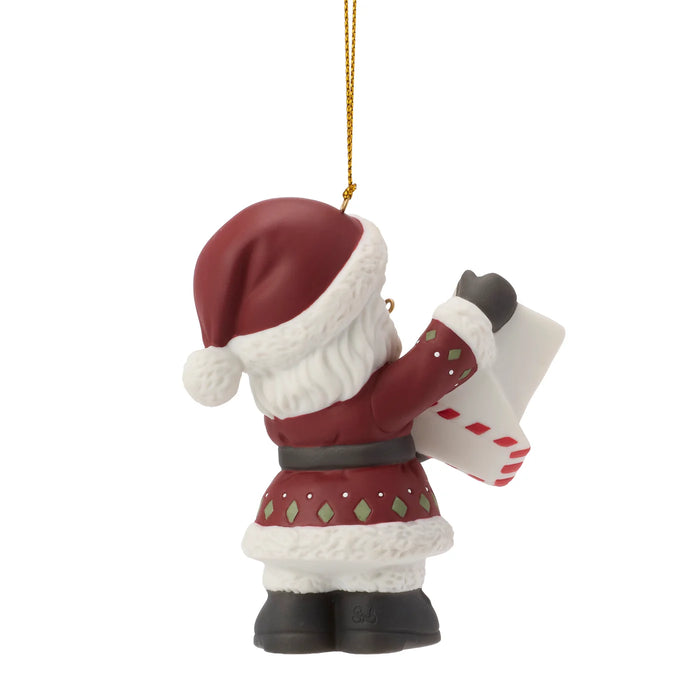 Santa Claus ornament holding a card on a white background