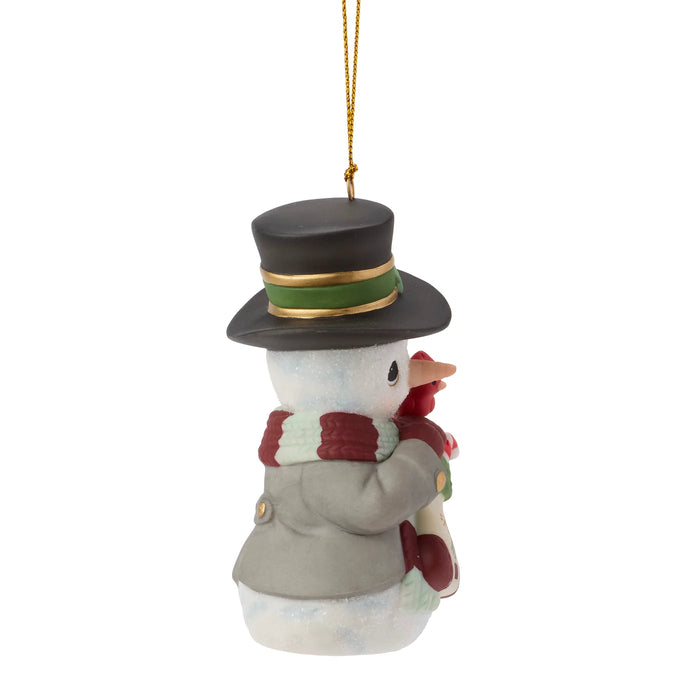 Snowman ornament with top hat and scarf on a white background