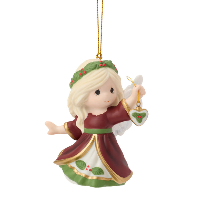 Christmas angel ornament with a gold halo and green headband on a white background