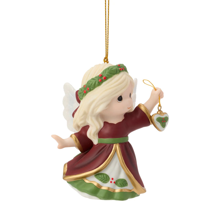Christmas angel ornament with a heart-shaped tag on a white background