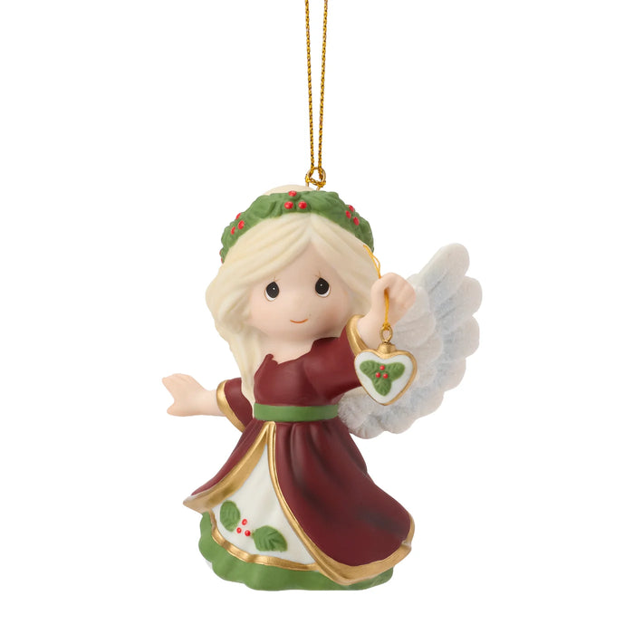 Christmas angel ornament with a heart-shaped tag on a white background