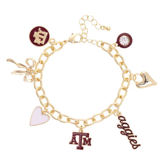 Gold bracelet with various charms including a heart, 'ATM', and 'aggies' on a white background