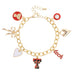 Gold charm bracelet with various charms on a white background