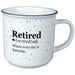 White mug with black speckles featuring text about retirement on a white background