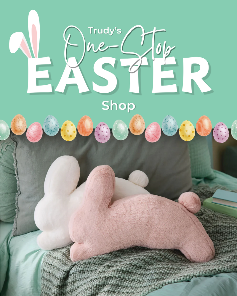Promotional image for Trudy's One-Stop Easter Shop with plush toys and Easter decorations on a bed.